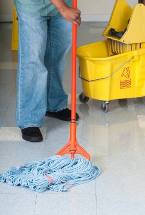 BlackHawk Janitorial Services LLC janitor in Scottdale, GA mopping floor.